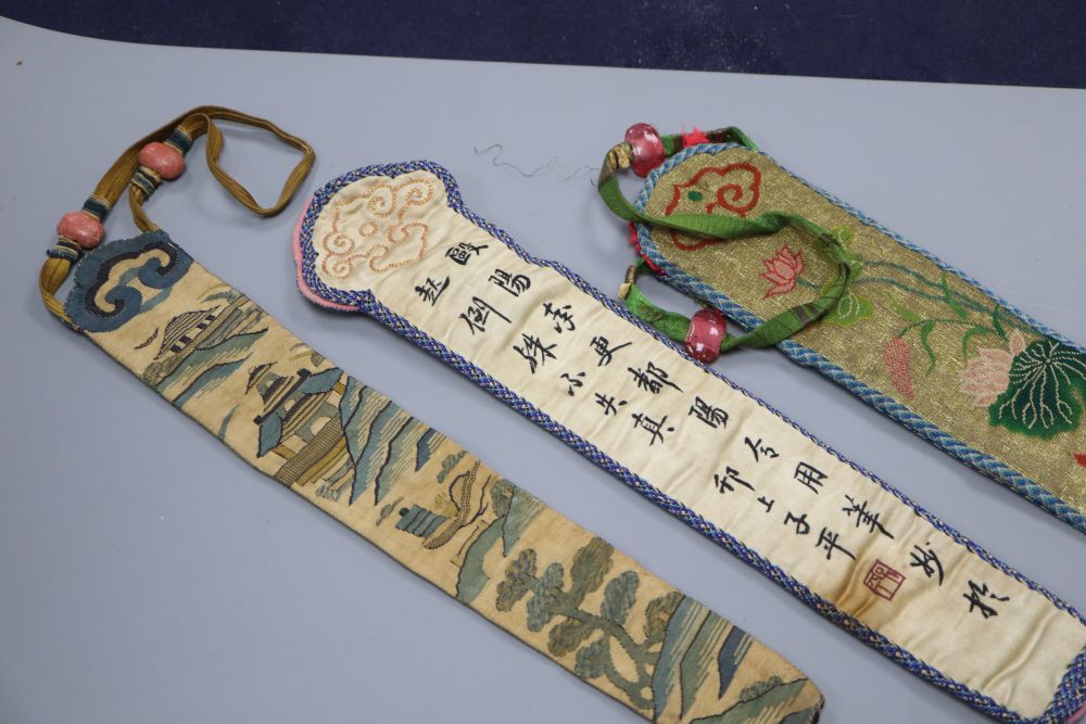 Three embroidered Chinese fan cases, one Kesi and woven with a tree, river and temple motifs, another with fine embroidered duck and li